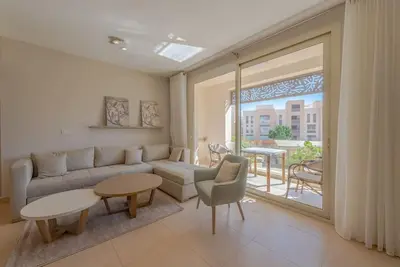 a living room with a couch and a table at Modern 1BR, Mangroovy, Gouna - 1BR, Pool, & Beach in Hurghada