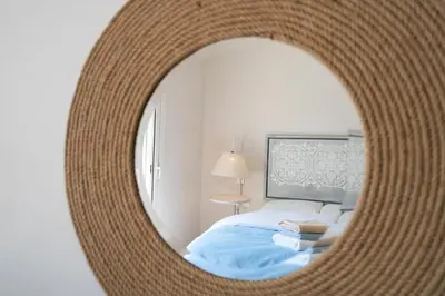 a bedroom with a bed and a round mirror at The Sandy Feet Sea Front in Hurghada