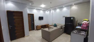 a living room with a couch and a tv at Ikea flat 9 in Hurghada