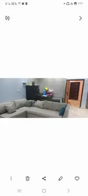 a living room with a couch and a table at Ikea flat 9 in Hurghada