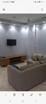 a living room with a couch and a flat screen tv at Ikea flat 9 in Hurghada