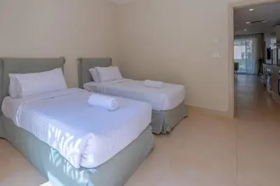 two beds with white sheets in a room at Pool Front 2BR in Mangroovy - El Gouna, Beach Access in Hurghada