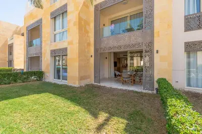 a large building with a lawn in front of it at Pool Front 2BR in Mangroovy - El Gouna, Beach Access in Hurghada