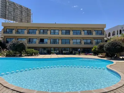 a large swimming pool in front of a building at Studio in old Sheraton in Hurghada