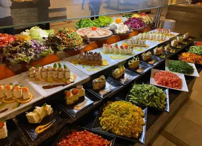 a buffet filled with lots of different types of food at Hurghada Mirage Bay Hotel & Aquapark in Hurghada