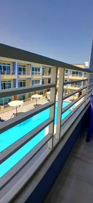 a balcony of a building with a swimming pool at Hurghada Mirage Bay Hotel & Aquapark in Hurghada