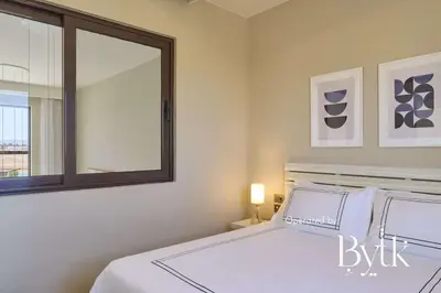 a bedroom with a bed with a mirror and a window at BYTK - Casamigos in Hurghada