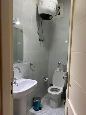 a small bathroom with a toilet and a sink at Fabulous studio 8 mins drive to El Gouna gates in Hurghada