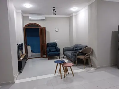 a living room with chairs and a couch and a table at 2 room Appartement in Hurghada