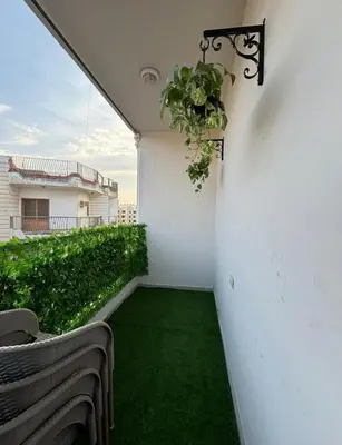 a balcony with a plant hanging from a wall at 2 room Appartement in Hurghada