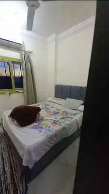 a bedroom with a bed with a blue head board at Hurghada in Hurghada