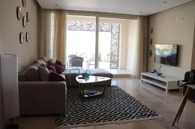 a living room with a couch and a table at Cozy Ground floor-Pool view - Mangroovy El Gouna in Hurghada
