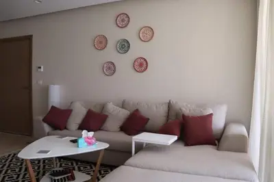 a living room with a couch and plates on the wall at Cozy Ground floor-Pool view - Mangroovy El Gouna in Hurghada