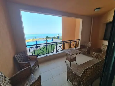 a balcony with chairs and a view of the ocean at One bedroom in the view in Hurghada