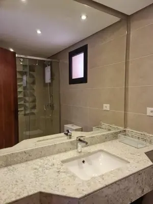a bathroom with a sink and a shower at One bedroom in the view in Hurghada