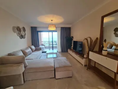 a living room with a couch and a mirror at One bedroom in the view in Hurghada