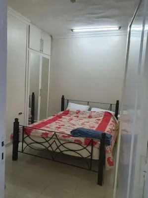 a bedroom with a bed with a red comforter at Hurghada city center in Hurghada