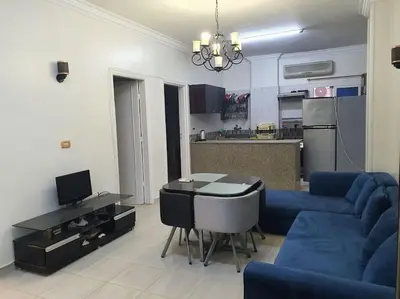 a living room with a blue couch and a table at Hurghada city center in Hurghada