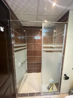 a shower with a glass door in a bathroom at Florenza Khamsin Resort in Hurghada