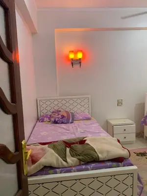 a little girl laying on a bed in a room at Welcome to LLL (Love Life Luxor) in Luxor