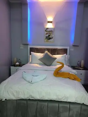 a bedroom with a large bed with a yellow ribbon on it at Luxurious Studio Apartment. in Luxor