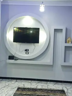 a flat screen tv on a wall in a room at Luxurious Studio Apartment. in Luxor