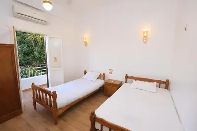 two beds in a room with a window at Pearl of Luxor on the Nile -Apartment in Luxor