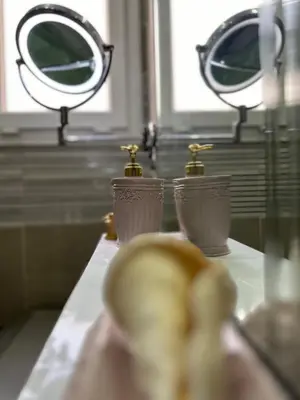 a counter top with two vases and a mirror at Horizon on Mamsha in Hurghada