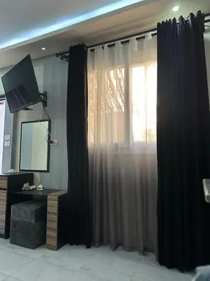 a bedroom with black curtains and a window at Horizon on Mamsha in Hurghada