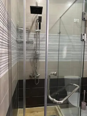 a shower with a glass door in a bathroom at Horizon on Mamsha in Hurghada