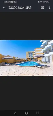 a picture of a resort with a pool and umbrellas at Captain Beach Resort Suite in Hurghada