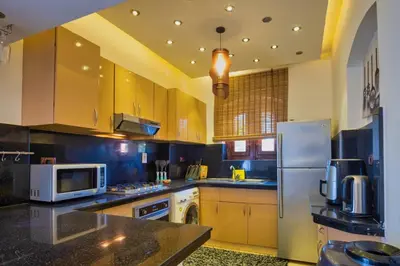a kitchen with a refrigerator and a microwave at Wast golf Y 41 in Hurghada