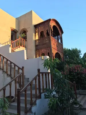 a building with a staircase and a balcony at Garden view guest house in Luxor