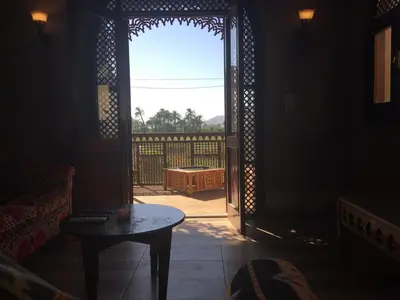 an open door to a patio with a table in a room at Garden view guest house in Luxor