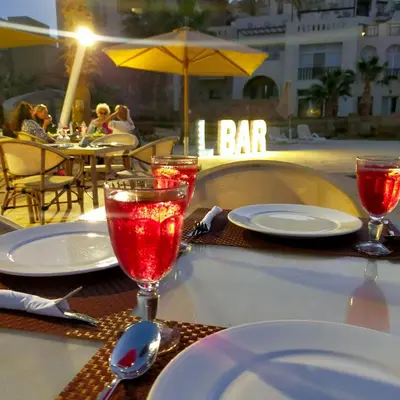 a table with plates and glasses on top of a table at Designer Loft mit grandiosem Meerblick am roten Meer in Hurghada