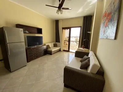 a living room with a couch and a refrigerator at Gravity Beach Apartment Non Egyptians only in Hurghada