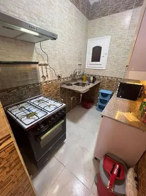 a kitchen with a stove and a sink at Spacious 2-Bedroom Apartment - Families Only in Hurghada