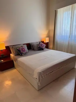 a large bed in a room with a window at Ancient Sands Golf Resort El Gouna Luxury Apartment in Hurghada