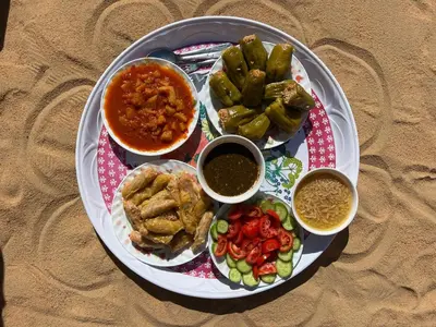 a plate of food with different types of food at Bafana Bafana Nubian Hostel in Najâ€˜ al MadÄbb