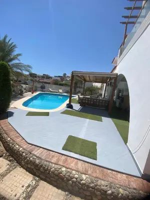 a villa with a swimming pool and a house at Hurghada Egypt Gable Al Haream Next-door to Hilton Plaza in Hurghada