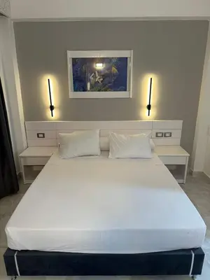 a large white bed in a room with two lights at Elixir in Hurghada