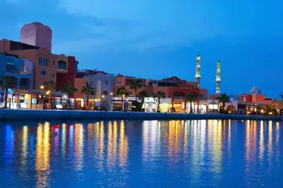 a city at night with lights on the water at Comfort Marine in Hurghada
