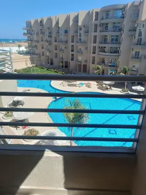 a view of a swimming pool from the balcony of a building at Princess resort flat no217 in Hurghada
