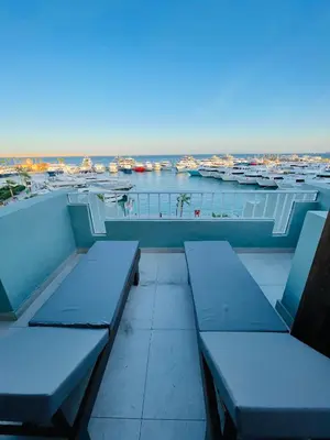 a balcony with benches and a view of a harbor at Marina Suite in Hurghada