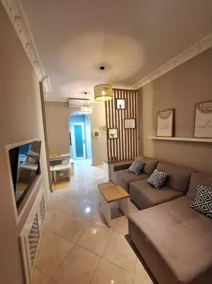 a living room with a couch and a tv at Hurghada Flat in Hurghada