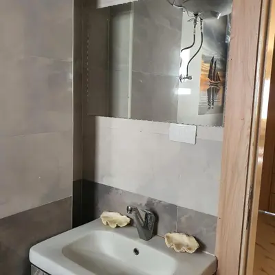 a bathroom with a sink and a mirror at Lareen's apartment in Quseir