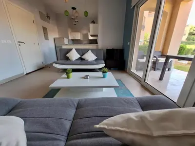 a living room with a couch and a table at El Gouna Waterside E 1-Bedroom Ground Floor Sleeps 4 Persons in El Gouna