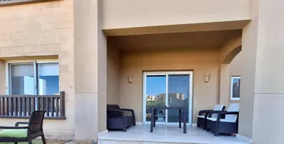 a patio with chairs and a table on a balcony at El Gouna Waterside E 1-Bedroom Ground Floor Sleeps 4 Persons in El Gouna