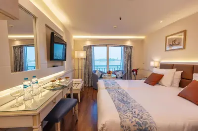a hotel room with a bed and a table with wine glasses at Orient Tower Prestige Nile Cruise-Every Monday from Luxor for 04 & 07 Nights - Every Friday From Aswan for 03 Nights in Luxor