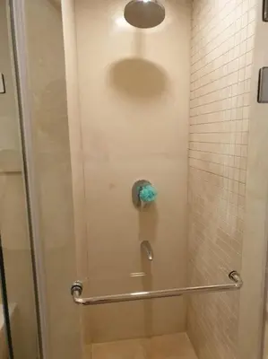 a bathroom with a shower with a glass door at Mangroovy- 1BR Sparkling Condo in Hurghada